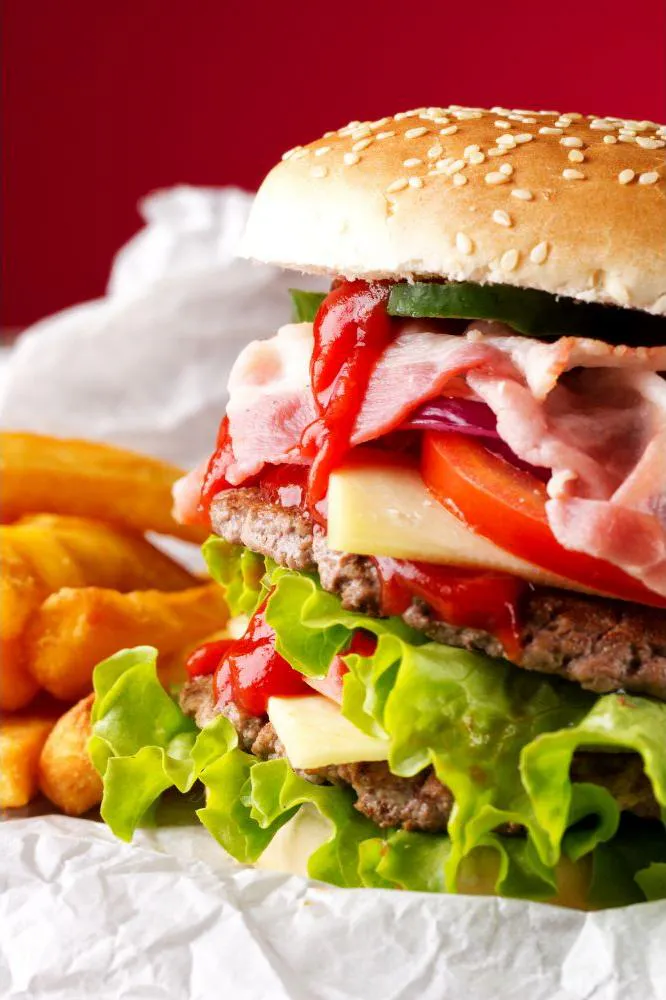 Double bacon cheeseburger with lettuce, tomato, and fries at Acbento, a Fast Food Restaurant in Flushing