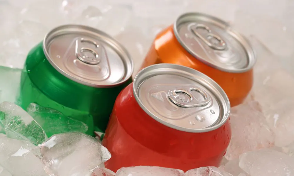 Colorful soda cans chilling on ice cubes at Acbento, a Fast Food Restaurant in Flushing
